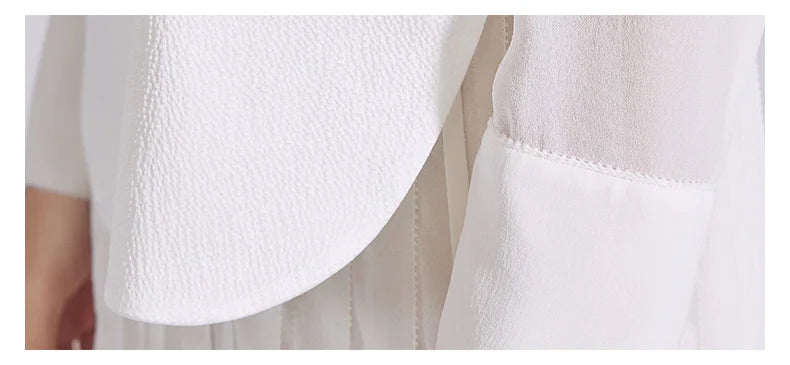 Close-up of the sleeve cuff on the chiffon dress with lace trim and button closure. From Borcelleclothes.