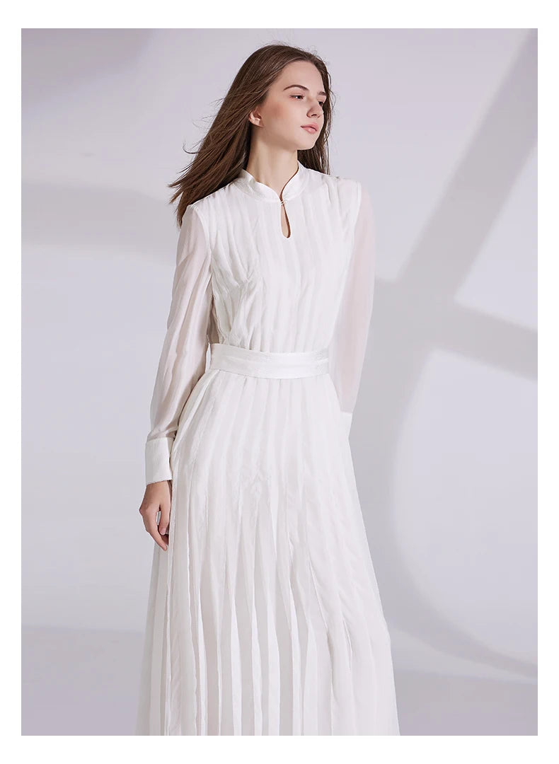 Model in chiffon silk dress, turned slightly to the side with a contemplative expression. From Borcelleclothes.