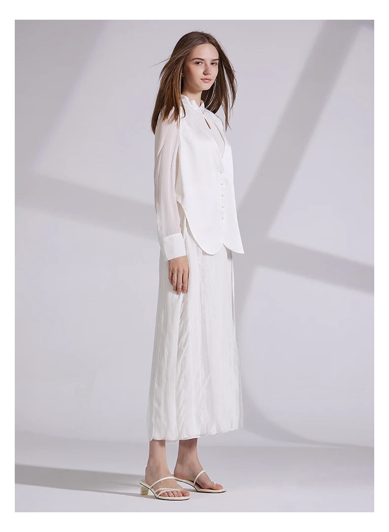 Model in full ensemble turned slightly to the side, showing layered silhouette. From Borcelleclothes.