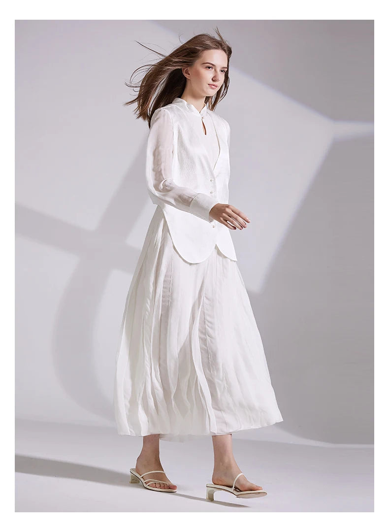 Model in full ensemble walking to the side, vest and dress visible. From Borcelleclothes.