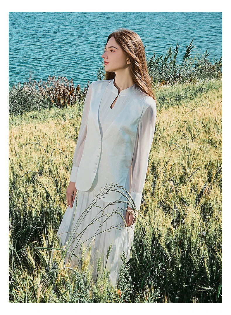 Model in in full ensemble, standing sideways in natural outdoor setting. From Borcelleclothes.