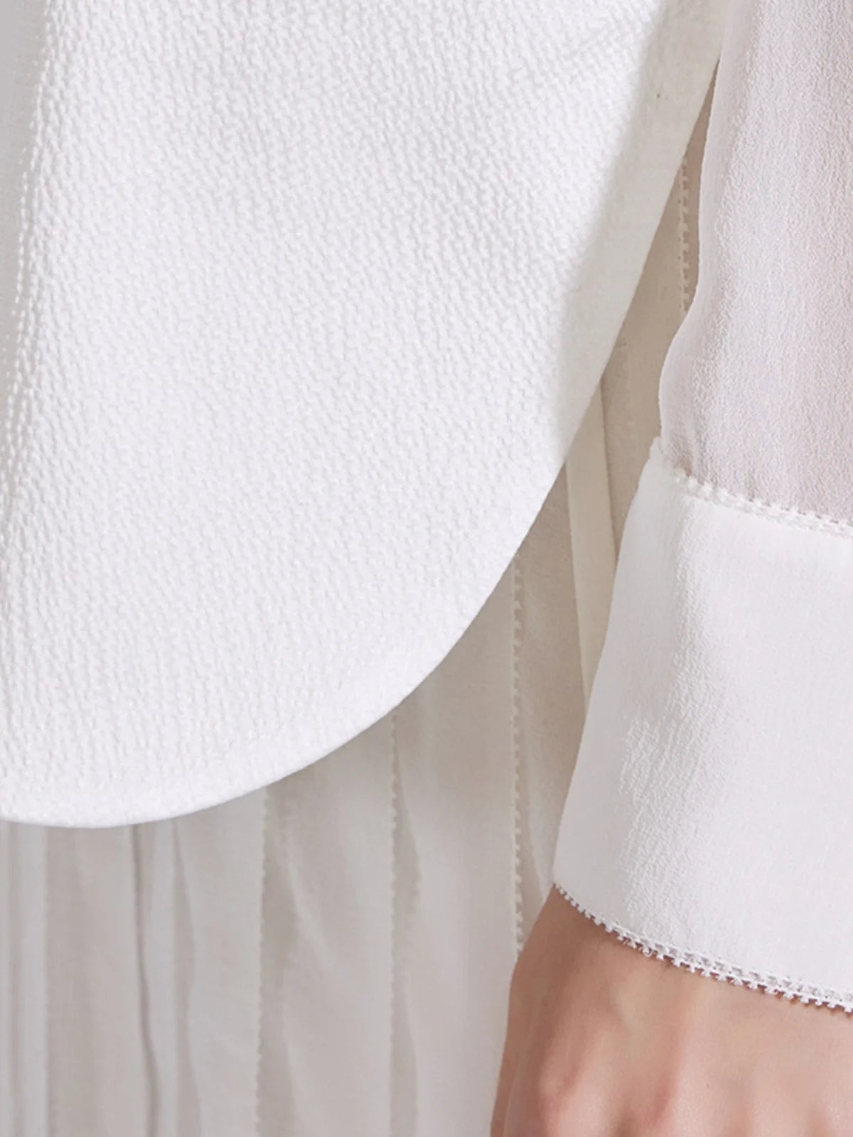 Detailed view of the dress cuff with lace trim and three pearl-like buttons. From Borcelleclothes.