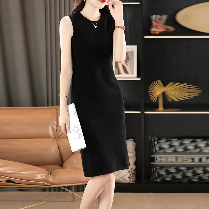 Women's Classic Minimalism Wool Dress in Onyx. A timeless knee-length wool dress inspired by Coco Chanel, featuring a sleek silhouette, delicate wool bands, and a discreet back slit for effortless elegance. From Borcelleclothes.