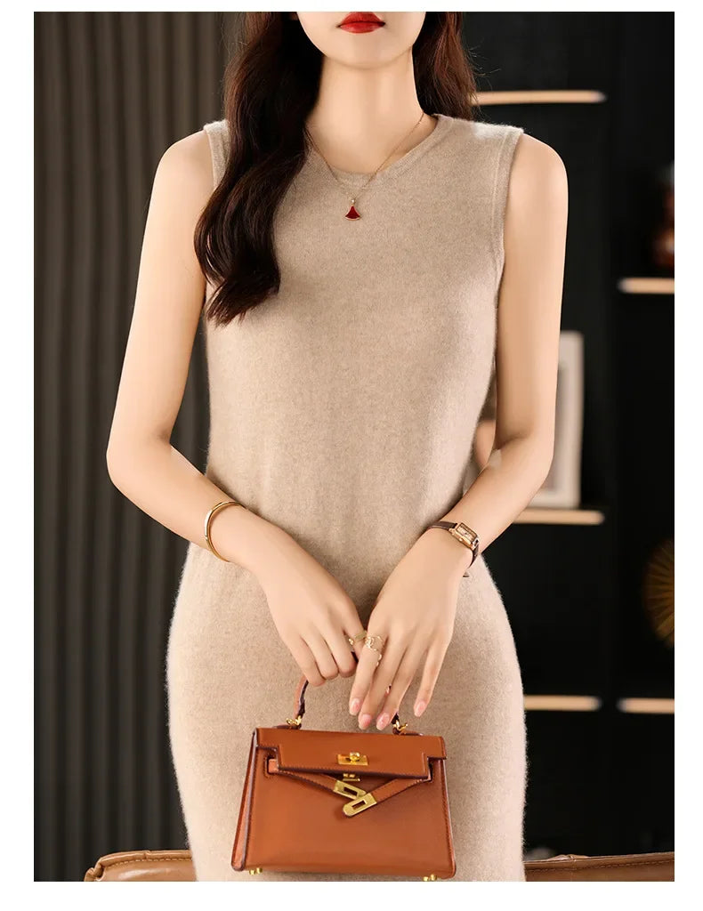 Woman in a Vanilla wool dress holding a bag. From Borcelleclothes.