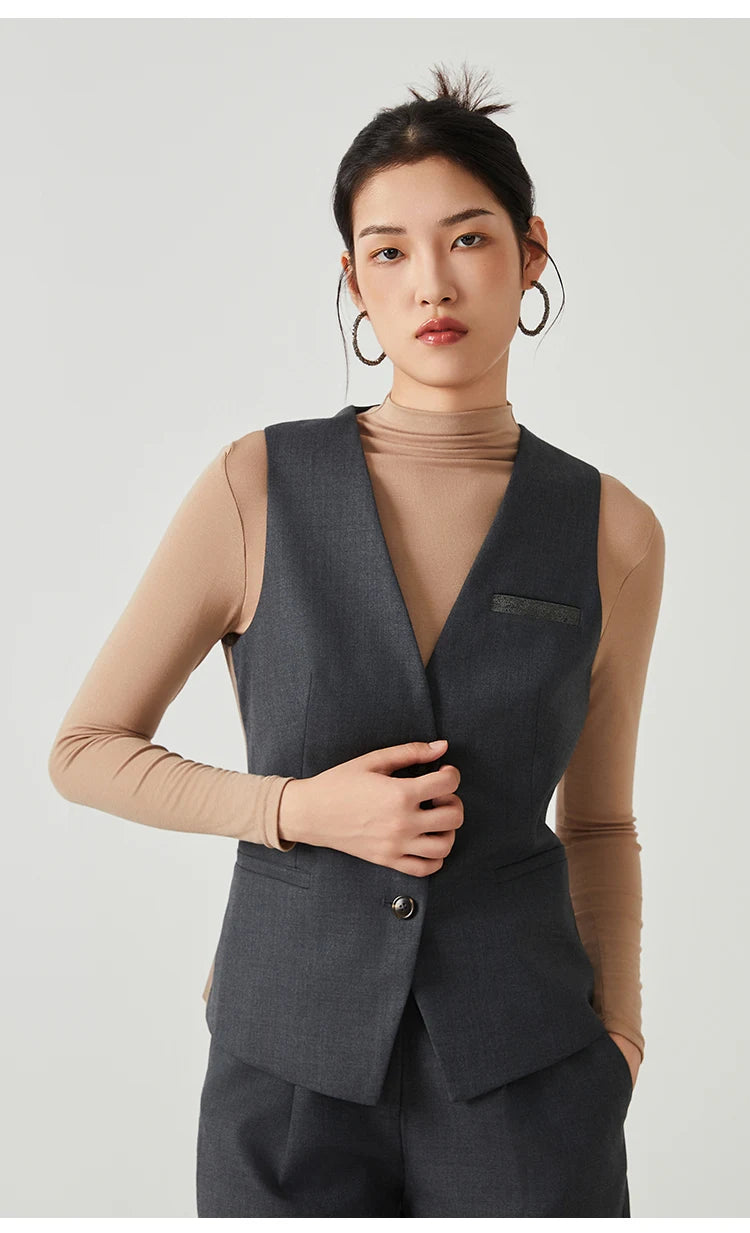 Woman wearing the Classical V-neckline vest in Davy Grey, touching the front side — From Borcelleclothes.
