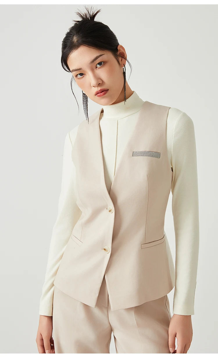 Woman in Classical V-neckline vest in Silver Pink, bent slightly to the side — From Borcelleclothes.