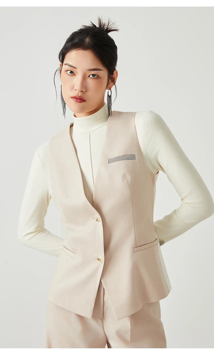 Model in Classical V-neckline vest in Silver Pink, posing with hands behind back — From Borcelleclothes.