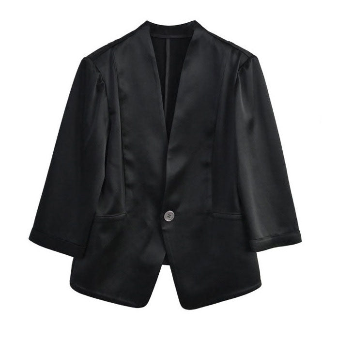 Front view of the collarless jacket in Onyx — clean neckline, precise construction, and curved lower panels in flowing silk. From Borcelleclothes.
