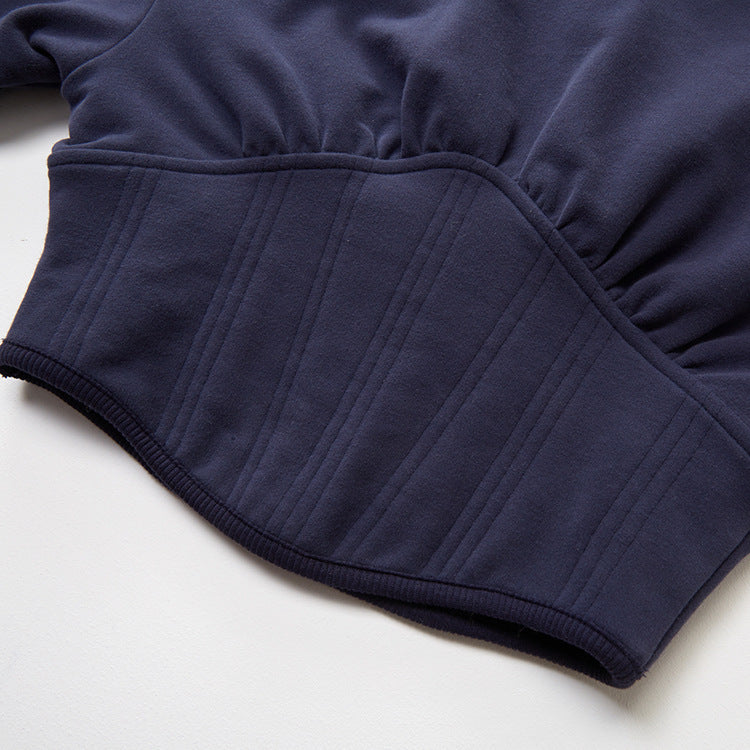The corset bottom of the Women's Contemporary Hooded Corset in Comet color, highlighting the ribbed bias detail that creates a flattering and cinched silhouette. This image emphasizes the unique fusion of casual comfort and structured elegance in this innovative design. From Borcelleclothes.