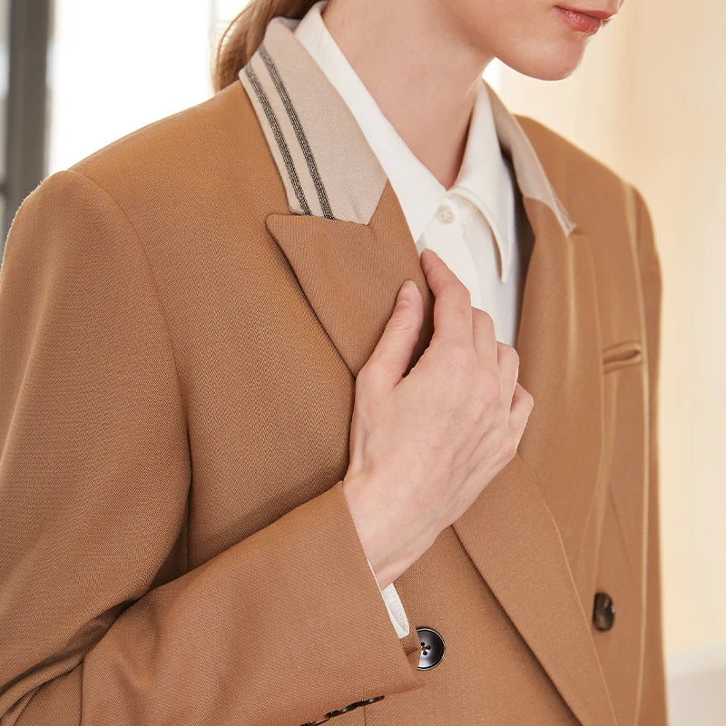 Upper part of woman wearing French Beige contrast-collar wool blazer with rhinestone-trimmed collar — From Borcelleclothes.