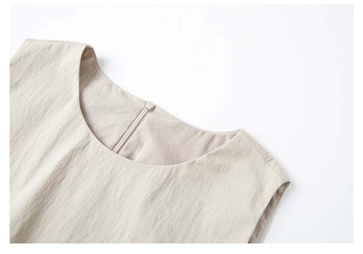 Detailed view of the round neckline on the crinkled sleeveless top — clean lines and soft structure. From Borcelleclothes.