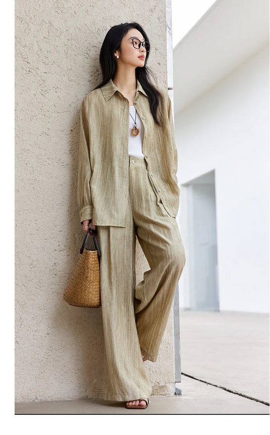 Woman in the crinkled Shadow set leaning against a wall, evoking relaxed summer ease. From Borcelleclothes.
