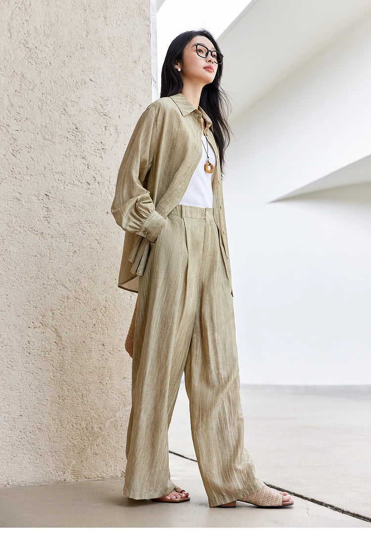 Shirt unbuttoned, model’s hand in pocket, revealing the set’s casual elegance. From Borcelleclothes.