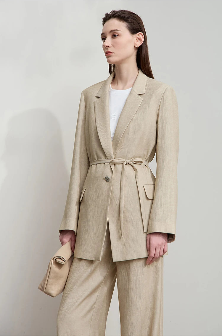 Woman turned slightly side in Soft Amber crinkled viscose blazer – From Borcelleclothes.