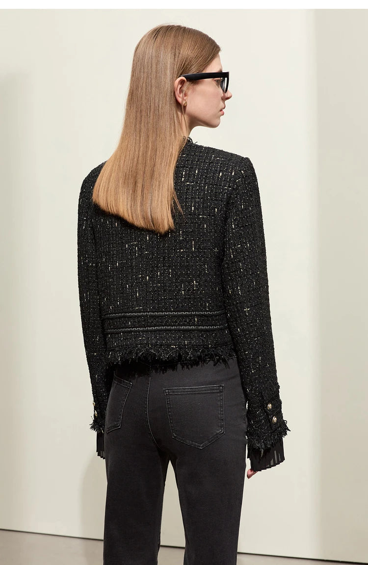 Model wearing Onyx cropped tweed jacket with sheer cuffs, back view – From Borcelleclothes.