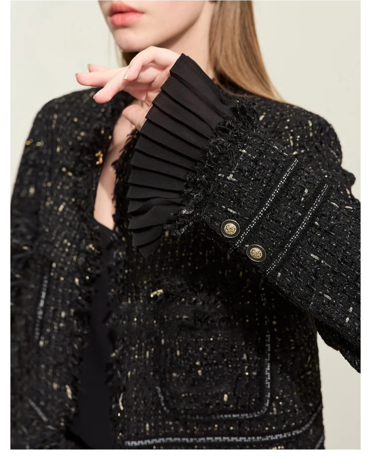 Model wearing Onyx cropped tweed jacket with sheer cuffs, bent arm showing pleated cuff – From Borcelleclothes.