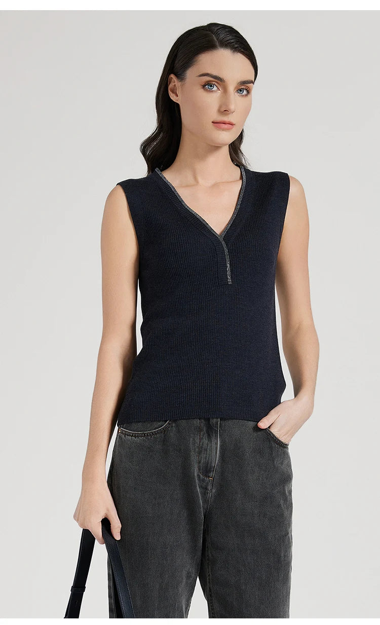 Model in Black Pearl top holding a bag while resting other hand in pocket, casual and composed. From Borcelleclothes.