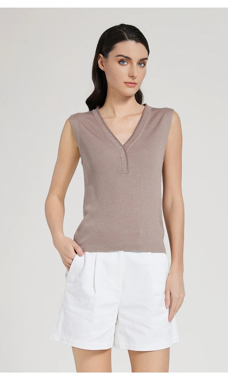 Model wearing Martini-colored ribbed top with curved V-neckline, hand resting in shorts pocket. From Borcelleclothes.
