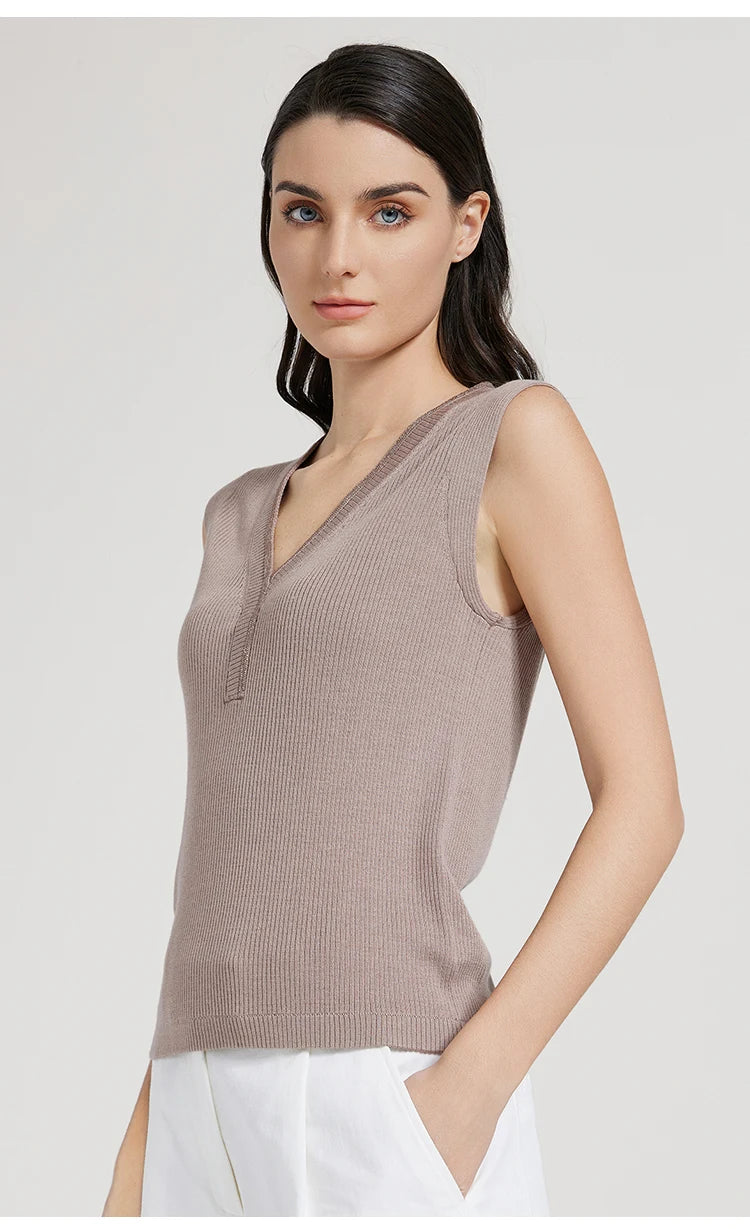 Side profile of model wearing Martini ribbed top with curved V-neck and armhole inserts. From Borcelleclothes.