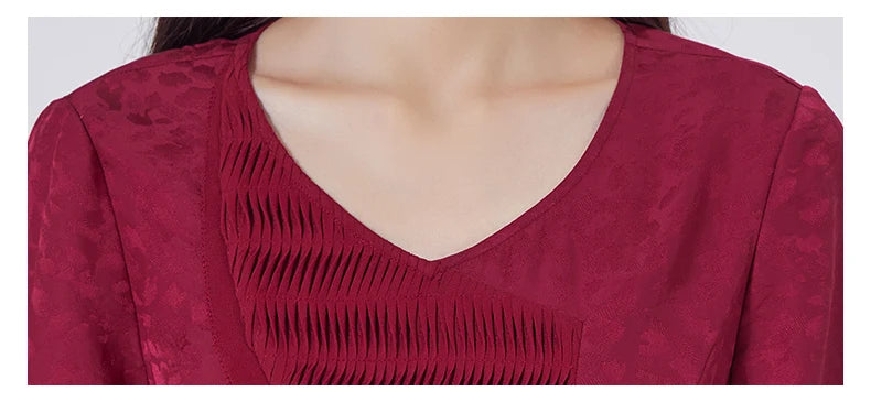 Close-up of the soft V-neckline with asymmetrical appliqué. From Borcelleclothes.