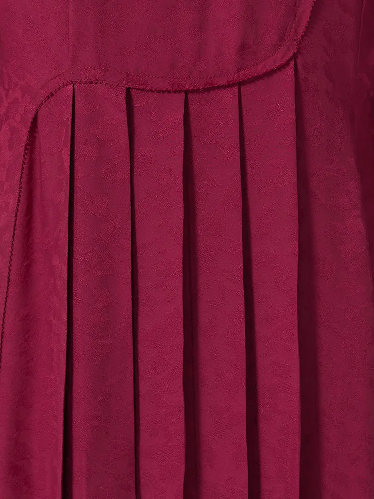 Knife pleat detail of the Dark Raspberry Jacquard Silk Dress. From Borcelleclothes.