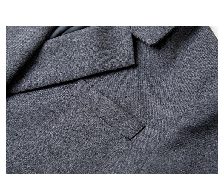 Close-up of chest pocket on women’s Davy Grey double-breasted blazer, tailored detail. From Borcelleclothes.
