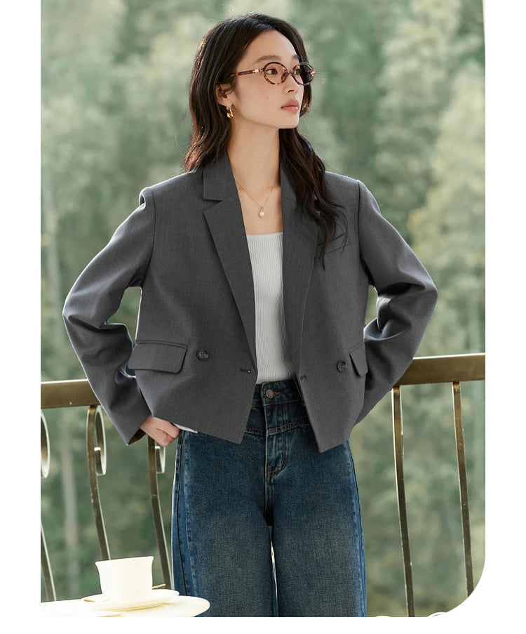 Model styling Davy Grey double-breasted blazer with hands on hips, flap pockets visible. From Borcelleclothes.