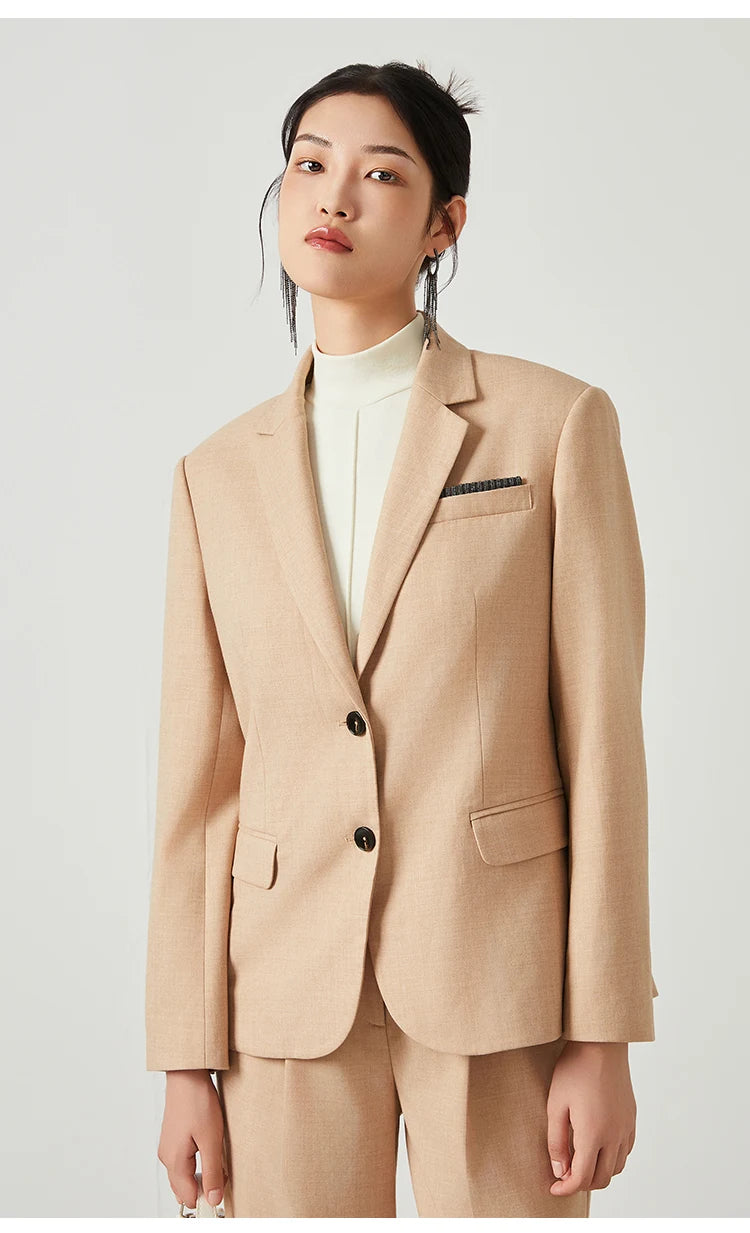 Woman in Desert Sand blazer turned slightly to the side, showing front and lapel details. From Borcelleclothes.