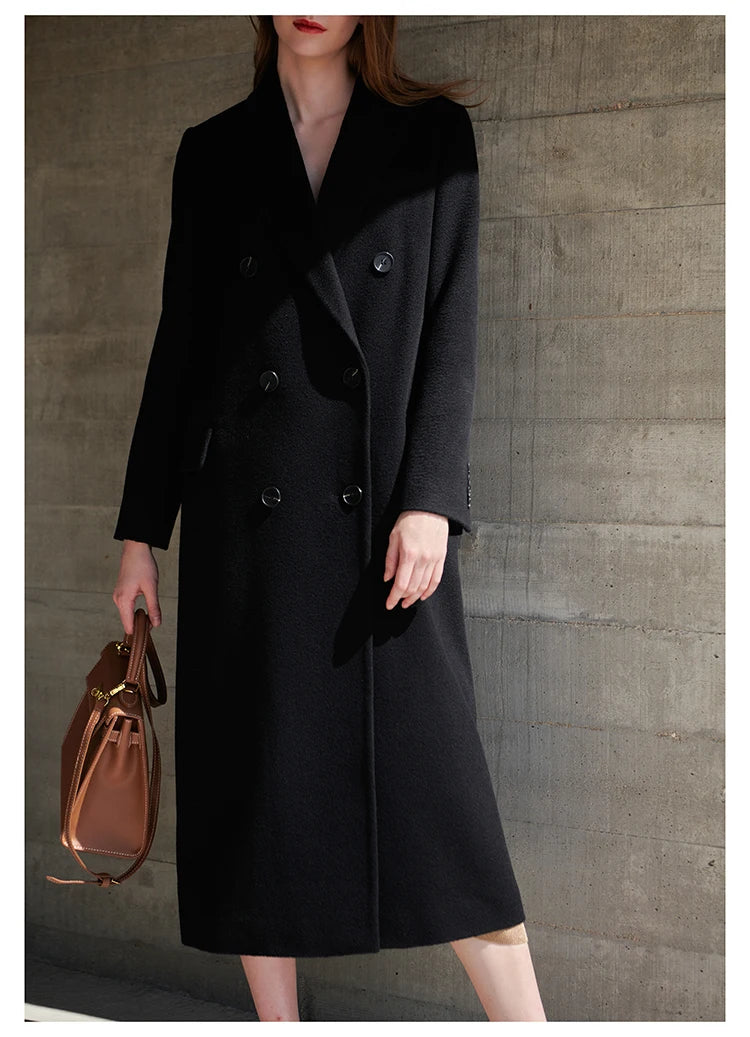 Model in the Onyx coat bending slightly forward, highlighting coat’s movement and softness. From Borcelleclothes.