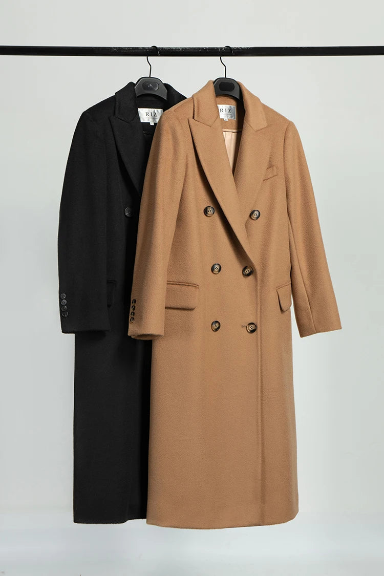 Onyx and Potters Clay coats hanging on hangers. From Borcelleclothes.