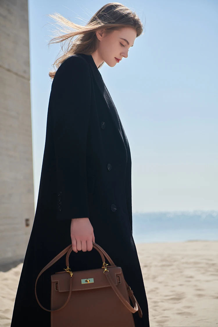 Model in an Onyx coat with head slightly bowed, highlighting lapels and collar. From Borcelleclothes.