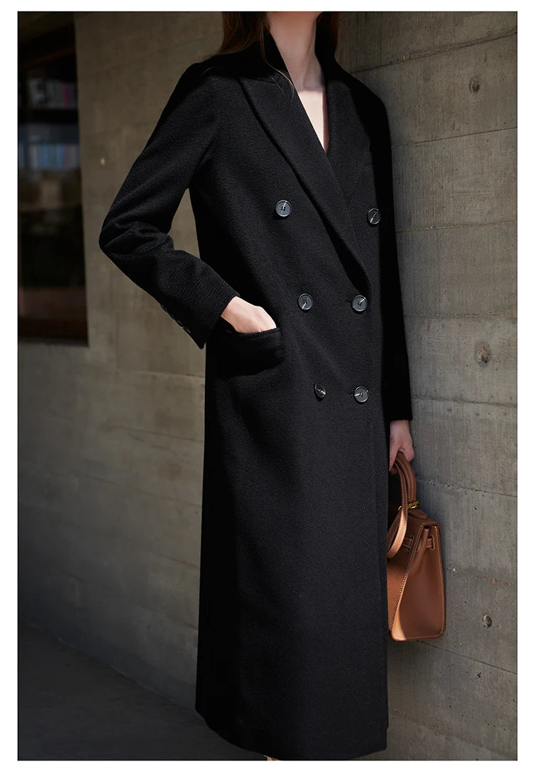 Woman wearing the Onyx cashmere wool coat with one hand tucked in a side pocket. From Borcelleclothes.