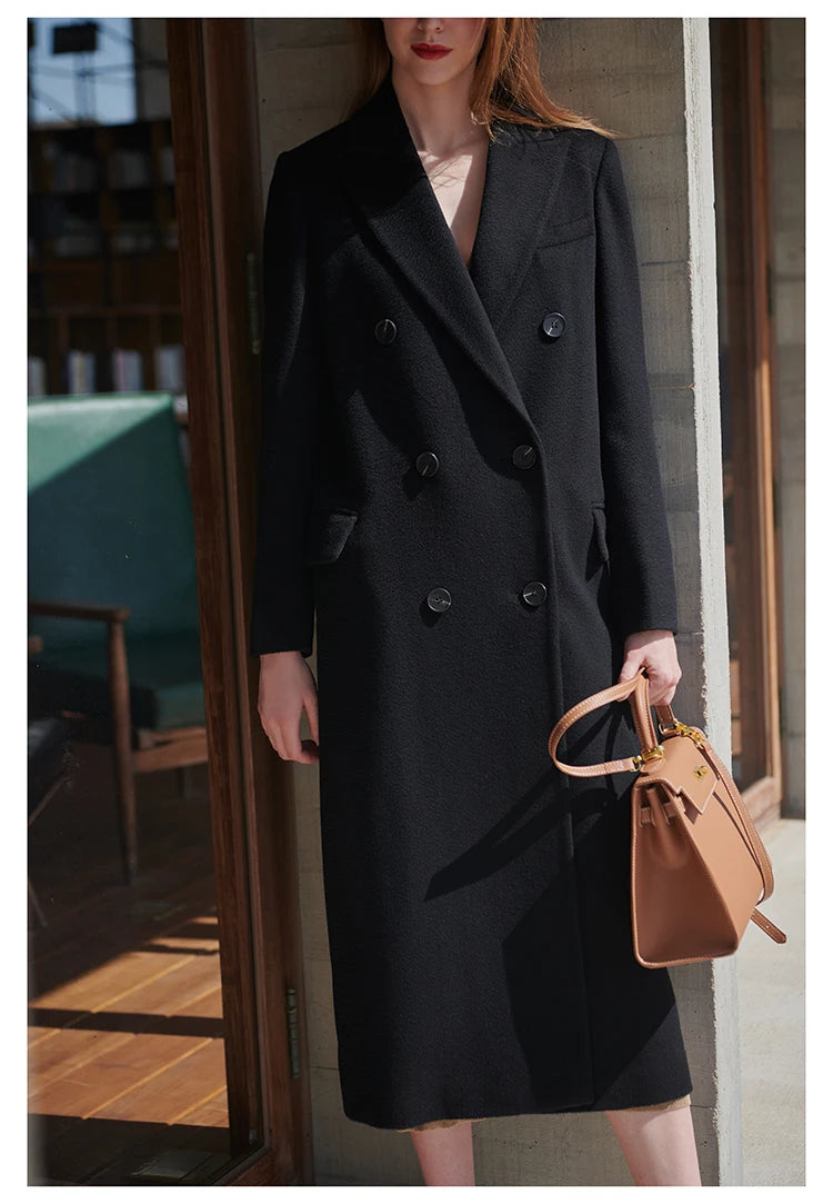 Model wearing an Onyx coat with one leg side, emphasizing mid-calf length. From Borcelleclothes.