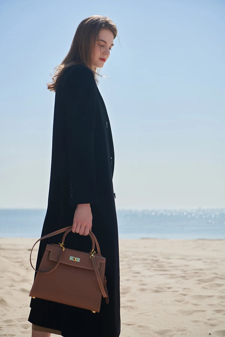 Side profile of the Onyx double-breasted cashmere wool coat showing clean lines and structure. From Borcelleclothes.