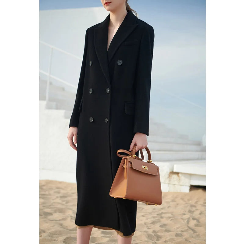 Women's double-breasted cashmere wool coat in Onyx, featuring peaked lapels and flap pockets. From Borcelleclothes.
