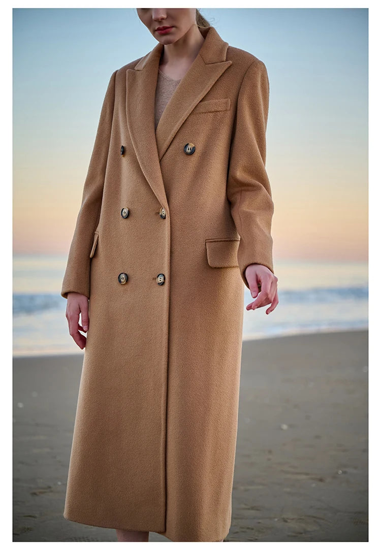 Model in Potters Clay coat with one arm extended, showcasing sleeve structure. From Borcelleclothes.