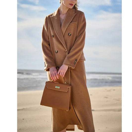 Women's double-breasted cashmere wool coat in Potters Clay, featuring peaked lapels and flap pockets. From Borcelleclothes.