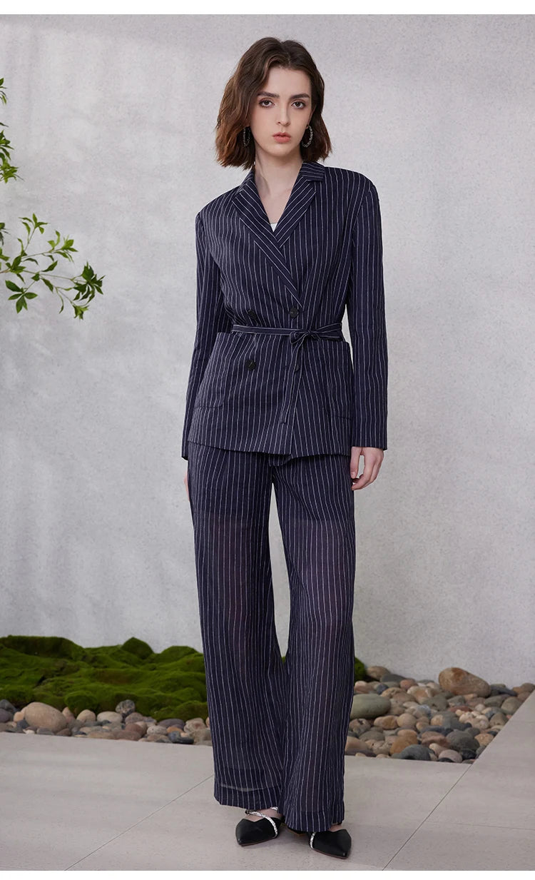 Mirage blue wide-stripe ramie blazer, model standing with bent leg, waist belt tied for a bold silhouette – From Borcelleclothes.