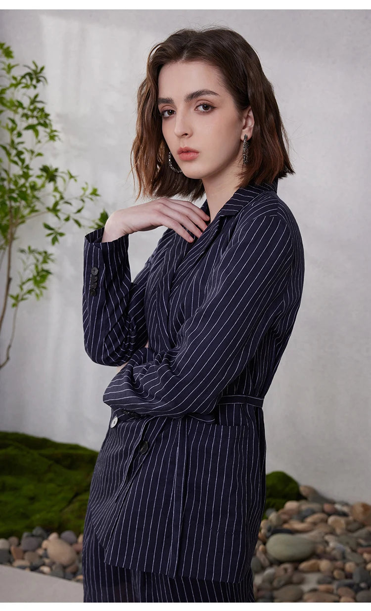 Mirage blue ramie blazer with bold stripes, model touching neck to emphasize lapels and double-breasted design – From Borcelleclothes.