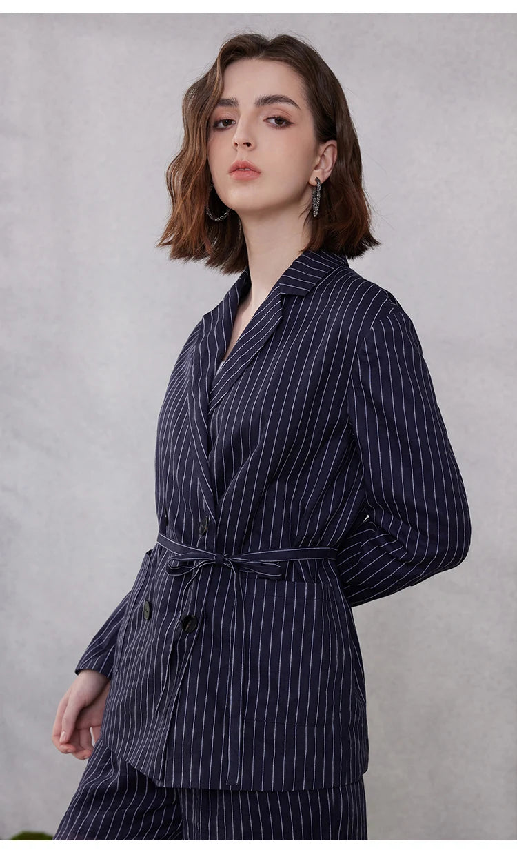 Mirage blue ramie blazer with bold stripes, model turned to the side with arm behind back, highlighting structured cut – From Borcelleclothes.