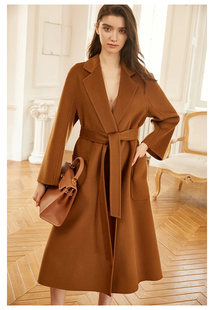 Model wearing a sienna double-sided cashmere wrap coat, bent leg pose. From Borcelleclothes.