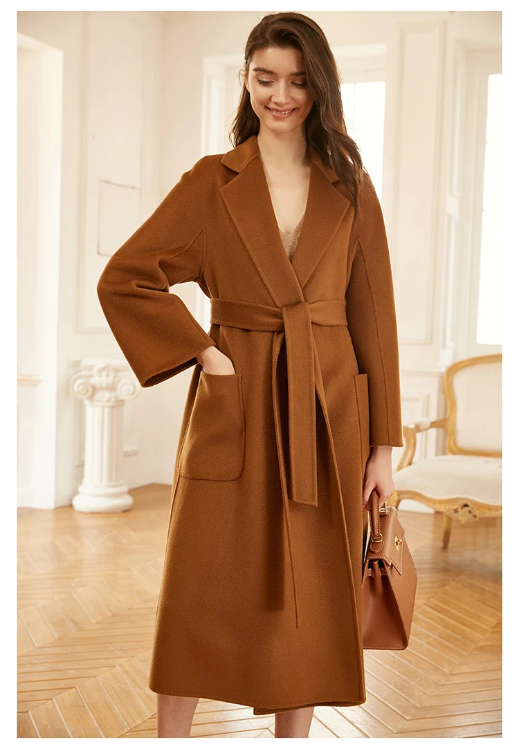 Model wearing a sienna double-sided cashmere wrap coat, smiling. From Borcelleclothes.
