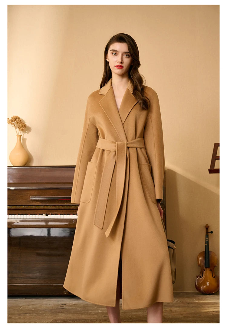 Model wearing a whiskey double-sided cashmere wrap coat, bent leg pose. From Borcelleclothes.