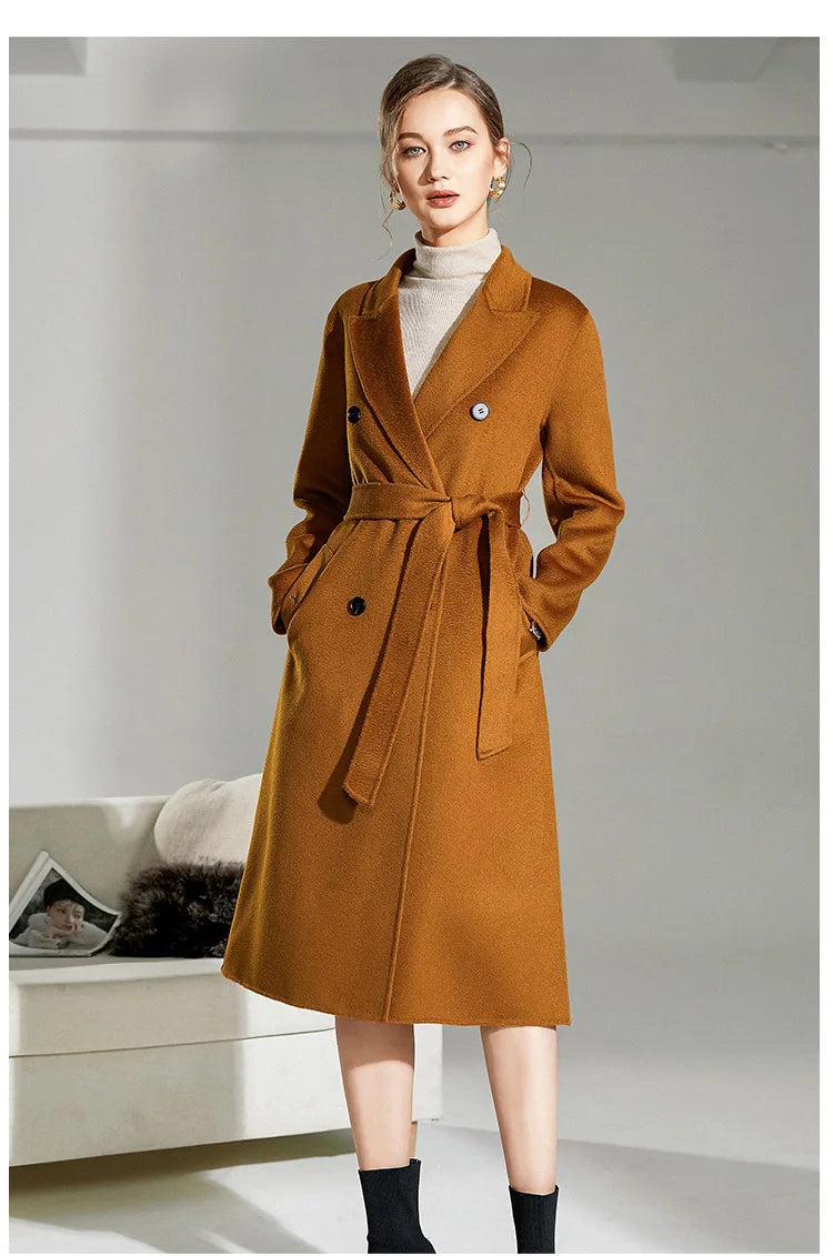 Model in the Women's Double-Sided Wool-Cashmere Coat in Bourbon, with hands in the welt pockets, highlighting the rich amber hue and structured fit. From Borcelleclothes.