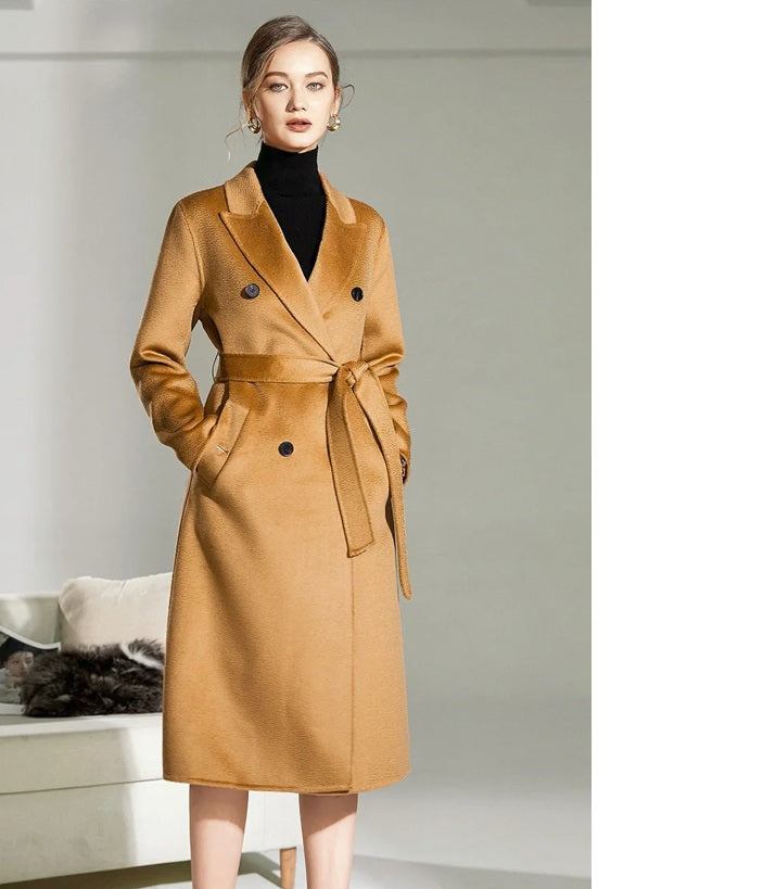 Model in the Women's Double-Sided Wool-Cashmere Coat in Brown Sugar, with hands in the welt pockets, showcasing the coat's functional design and tailored fit. From Borcelleclothes.