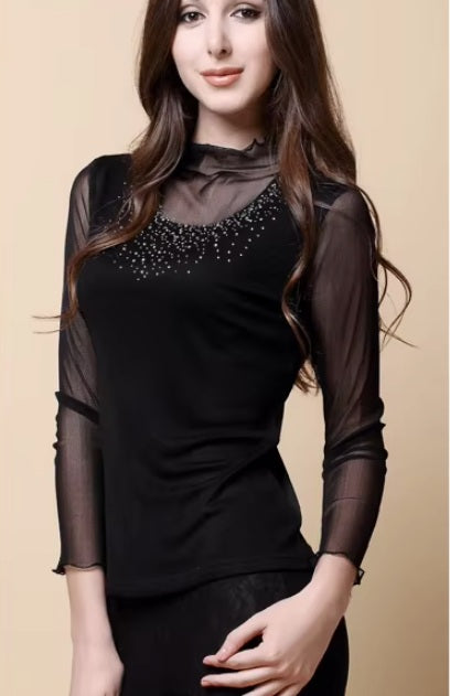 The side of a model wearing women's dual-layer silk top in Onyx, showing gauze overlay, ruffled high neck, and rhinestone accents. From Borcelleclothes.