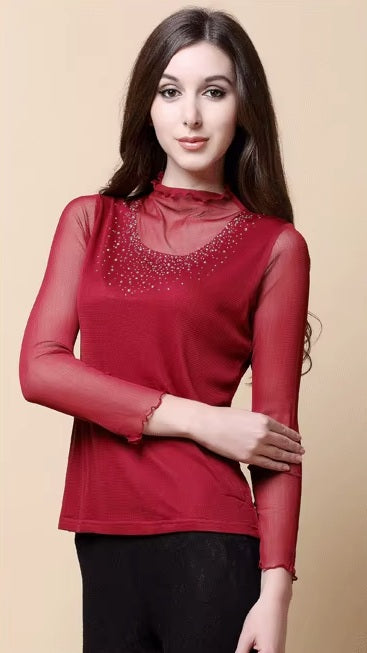 Model wearing women's dual-layer silk top in Vivid Burgundy, gently touching sleeve, highlighting the gauze silk. From Borcelleclothes.