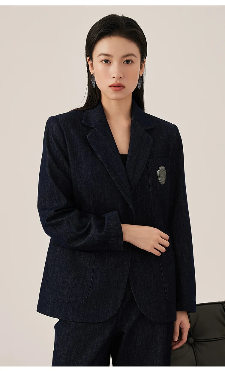 Ebony Clay denim blazer with model’s arm bent, emphasizing open vent cuffs stitched horizontally – From Borcelleclothes.