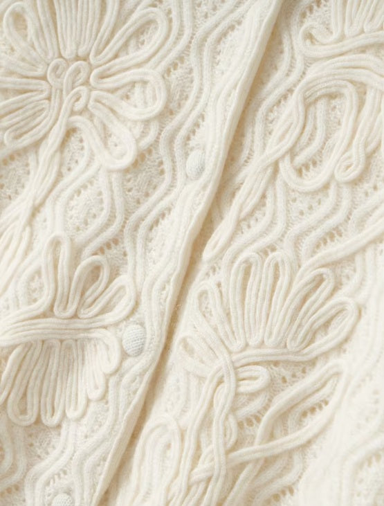 The crochet cord floral appliques on the women's Embossed Lace Cashmere Cardigan in Pearl Bush, showcasing its artistic craftsmanship, Borcelleclothes.