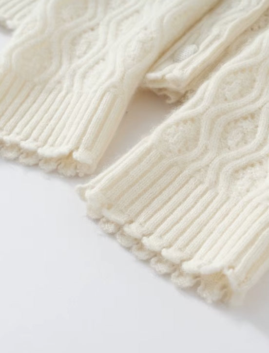 The cuffs on the women's Embossed Lace Cashmere Cardigan in Pearl Bush, featuring scalloped edges and intricate lace patterns, Borcelleclothes.